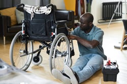 disabled-man-fixing-his-wheelchair-2023-11-27-05-03-31-utc