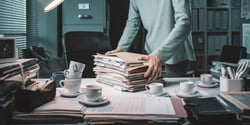 office-working-carrying-a-pile-of-paperwork-2023-11-27-05-28-47-utc