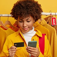 perplexed-woman-uses-credit-card-with-mobile