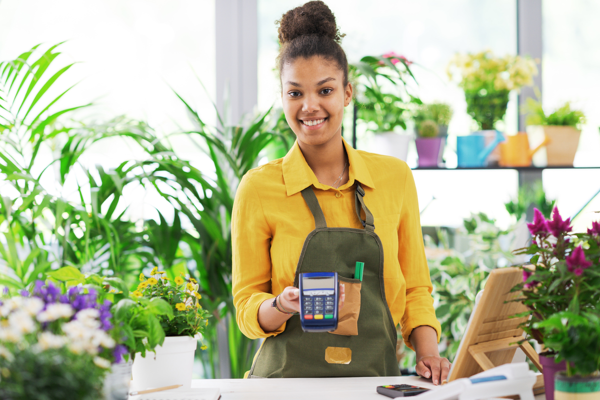 smiling-florist-holding-a-pos-terminal-2025-01-07-23-16-14-utc-1