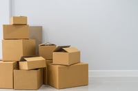 stack-of-cardboard-boxes-in-empty-room-2025-03-10-04-15-26-utc-1